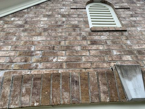 Brick Wall Above Arched Window with Cracks