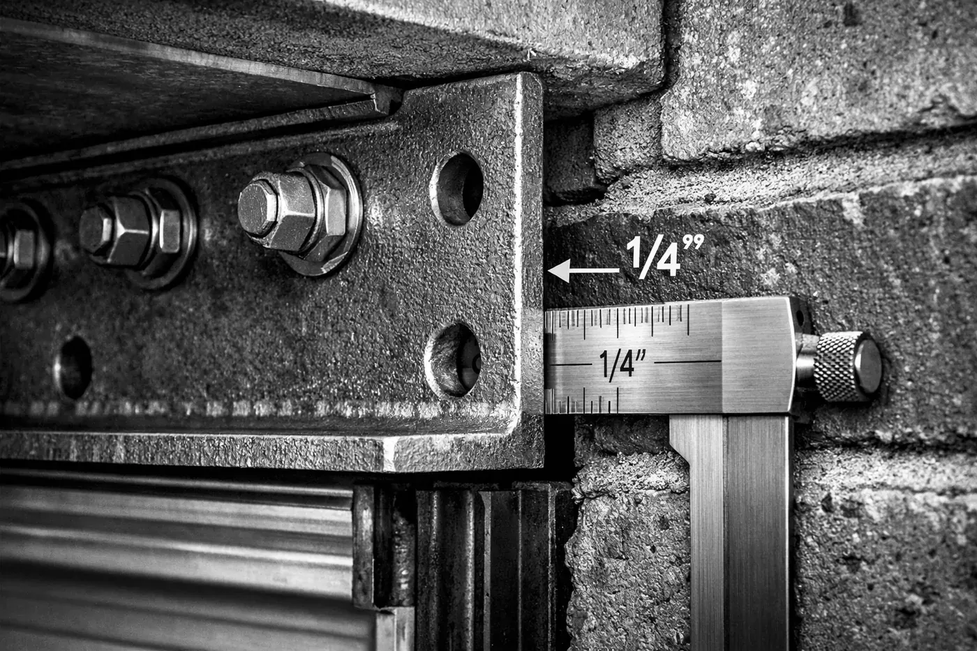 Steel lintel bracket showing engineered airspace gap for Dallas garage door brick repair