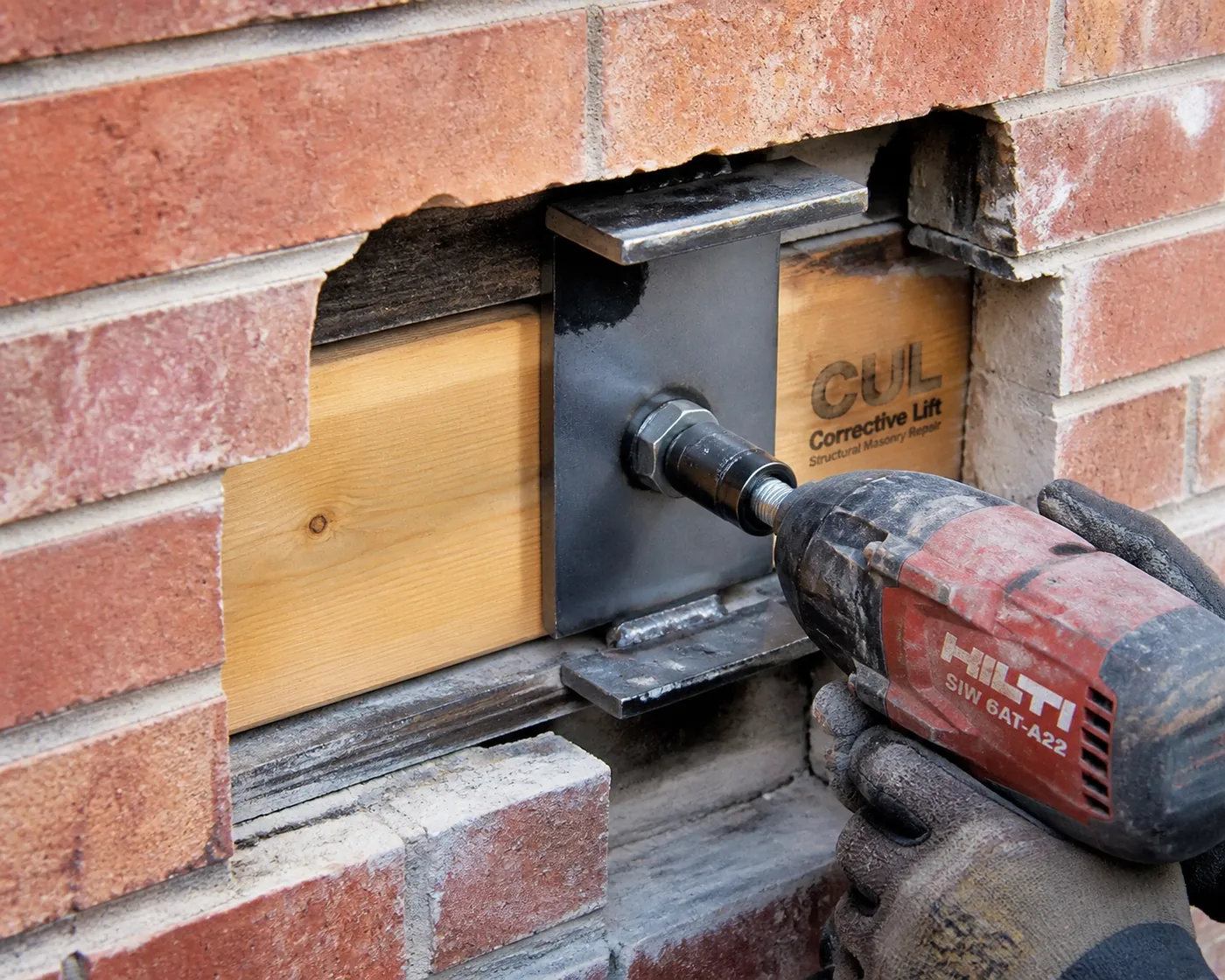 Professional installation of LintleLOCK structural hardware to secure a garage lintel and prevent rotational sagging.