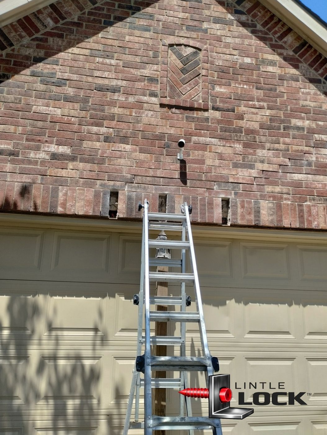 Visible signs of sagging brickwork and cracking above a garage door, prepped for lintel repair using LintleLOCK™ technology.